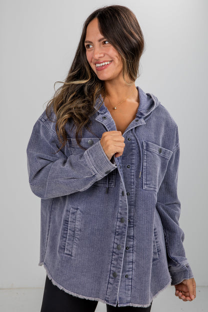 Woman wearing a blue denim jacket against a white background