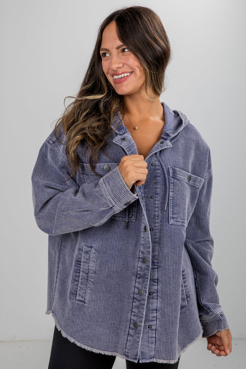 Woman wearing a blue denim jacket against a white background