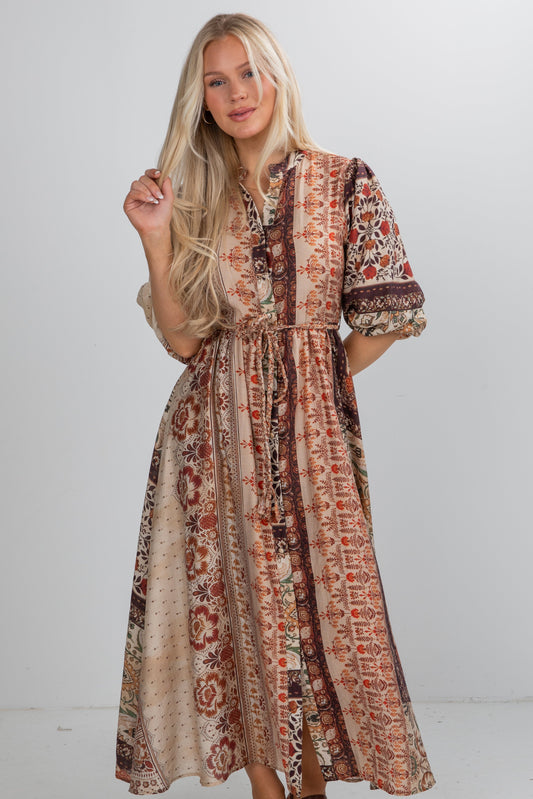 Woman wearing a patterned dress against a white background