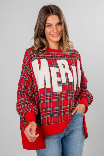 Woman wearing a red plaid sweater with 'Merry' text on a gray background